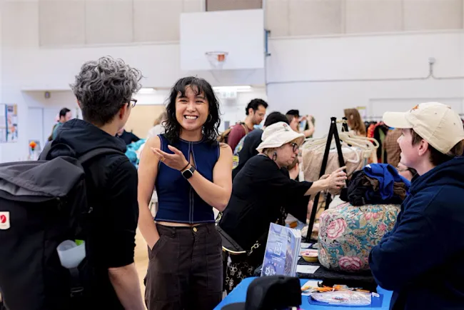 A person standing in a room with people around it