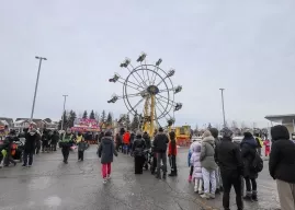 Line up of event attendees and a ferris wheel