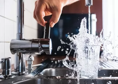 glass of water being filled from the tap