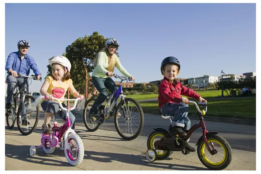 A family of four cycling together.