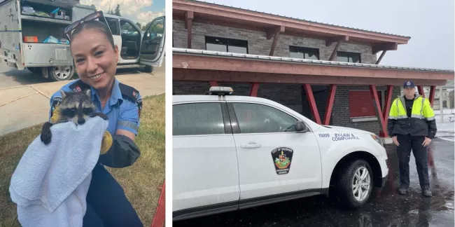 Officer holding animal and officer standing by car.