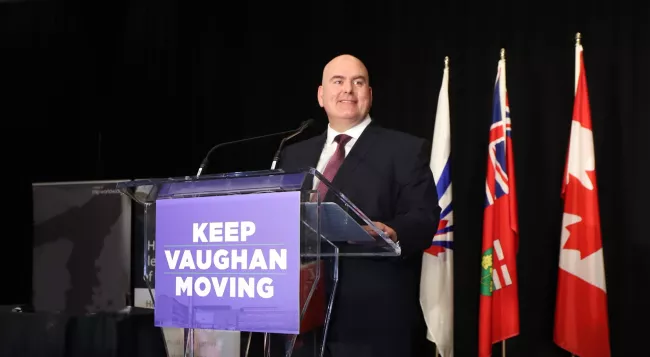 Mayor Steven Del Duca speaking at a podium