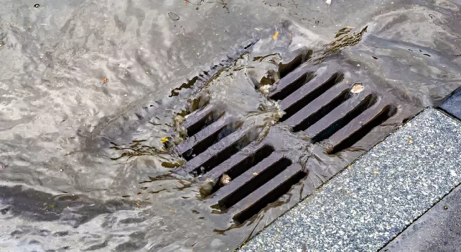 water draining into a catch basin 