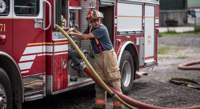 Fire fighter standing at a fire truck