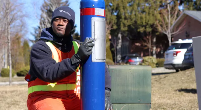 a water operator next to a sample station