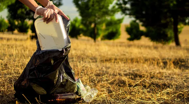 someone putting garbage in a bag