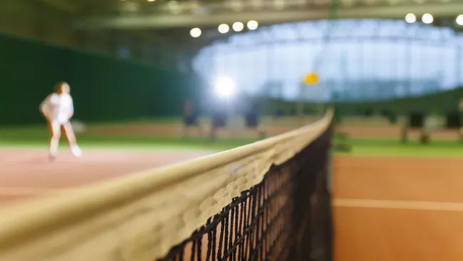 Blurry photo of an indoor tennis court