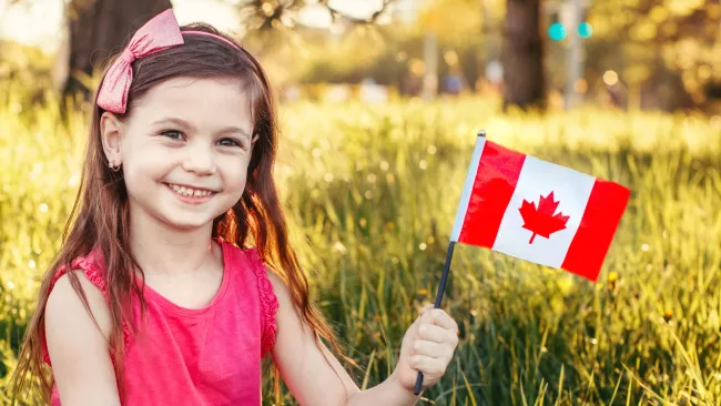 Little girl holding Canadian flag