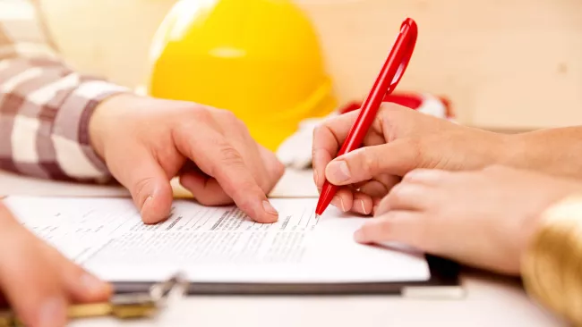 Person signing a contract with a contractor