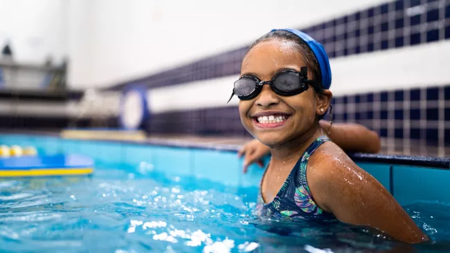 Girl in the pool smiling