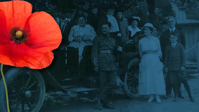 Black and white photo of soliders and their family with a red poppy