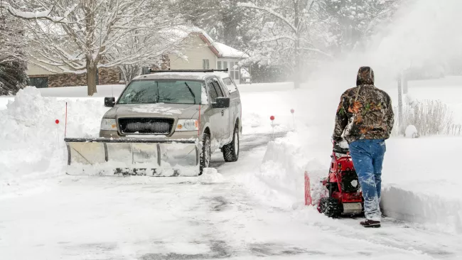 Someone shovelling driveway of snow