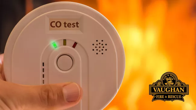 Someone testing a carbon monoxide alarm