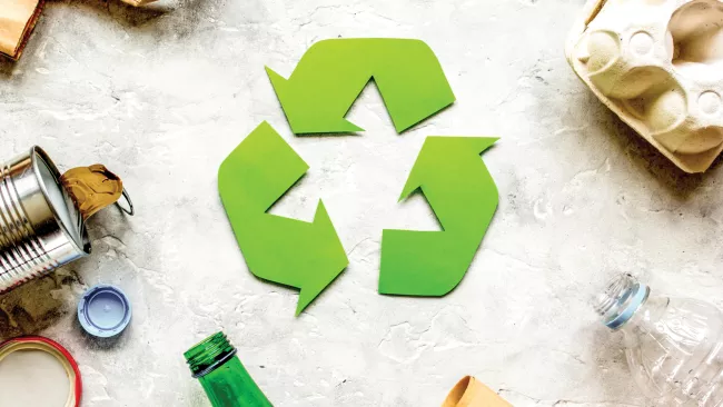 can, plastic bottles and cardboard carton around a recycle symbol