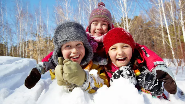 Three kids playing in the snow