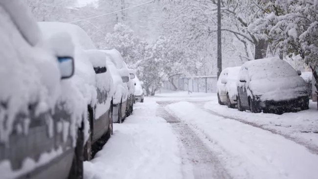 Parked cars on the road with snow