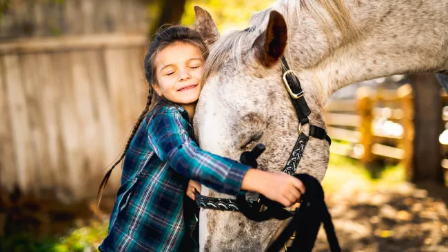 Girl hugging a horse