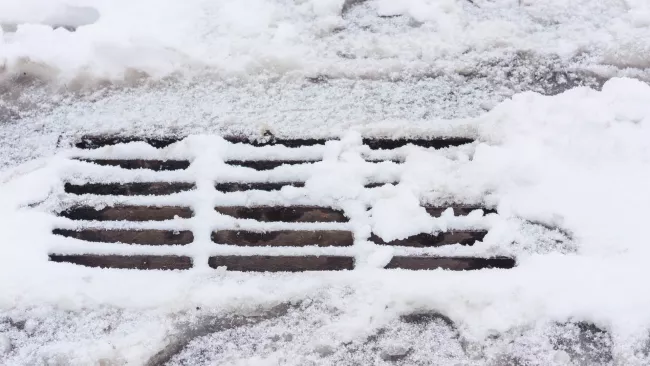 snow covering a catch basin