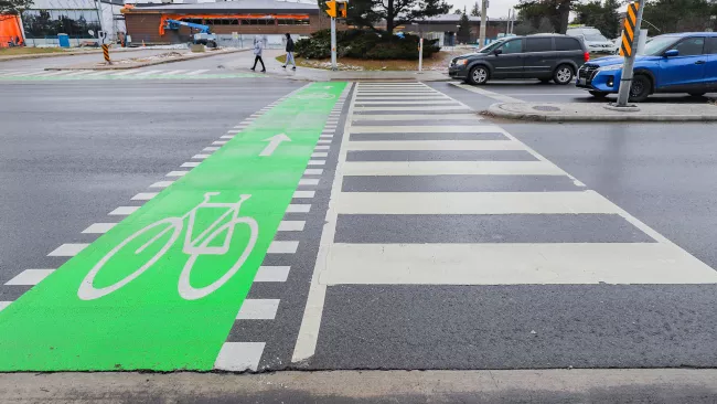 Crosswalk on a street in Vaughan with a bike lane. 