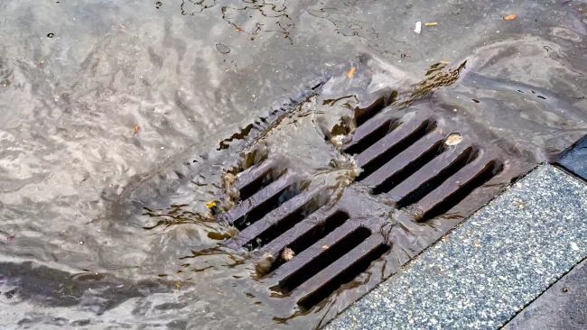 water draining into a catch basin 