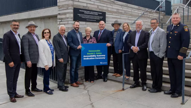 Mayor Del Duca, Members of Council, senior staff and Ruth Ann Oney pose in front of the plaque at City Hall. 