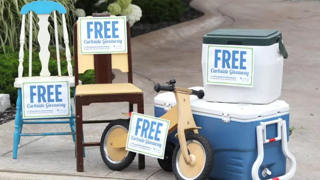 chairs, coolers and tricycle on a driveway