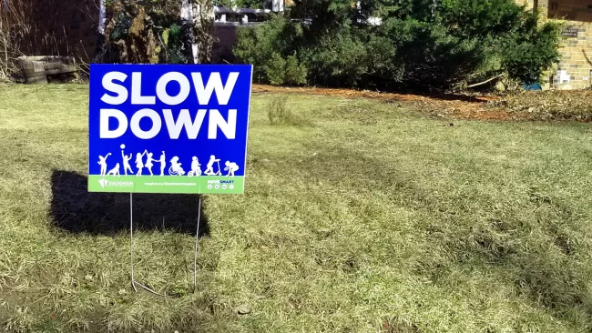 A #SlowDownVaughan sign on a front lawn