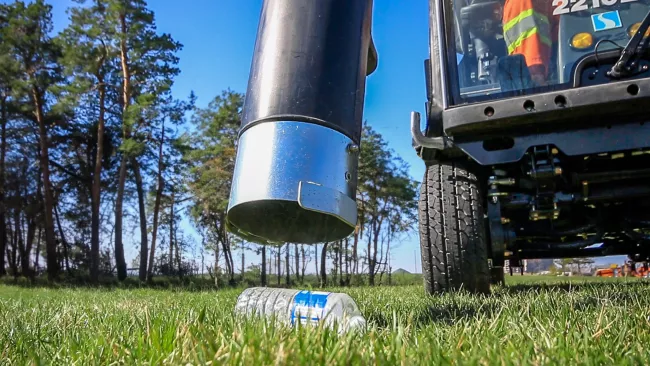 a Madvac cleaning up litter in the park