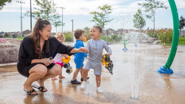 Family playing at a splashpad