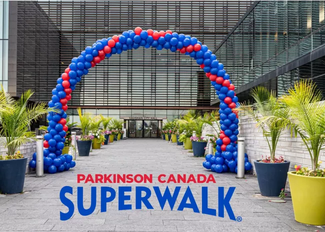 Blue and red balloon arch in front of the doors of Vaughan City Hall.