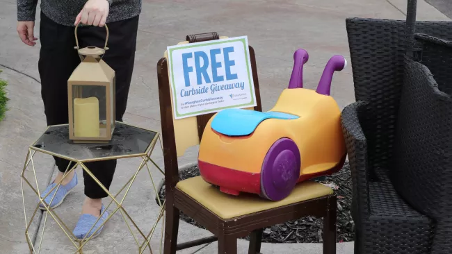 chairs, table, candle and children's toy at the curb