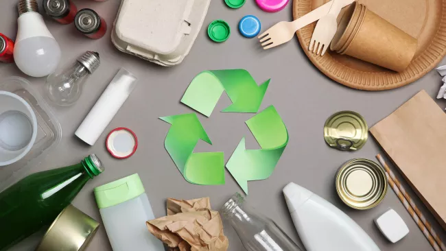 a variety of reusable materials around the recycle symbol