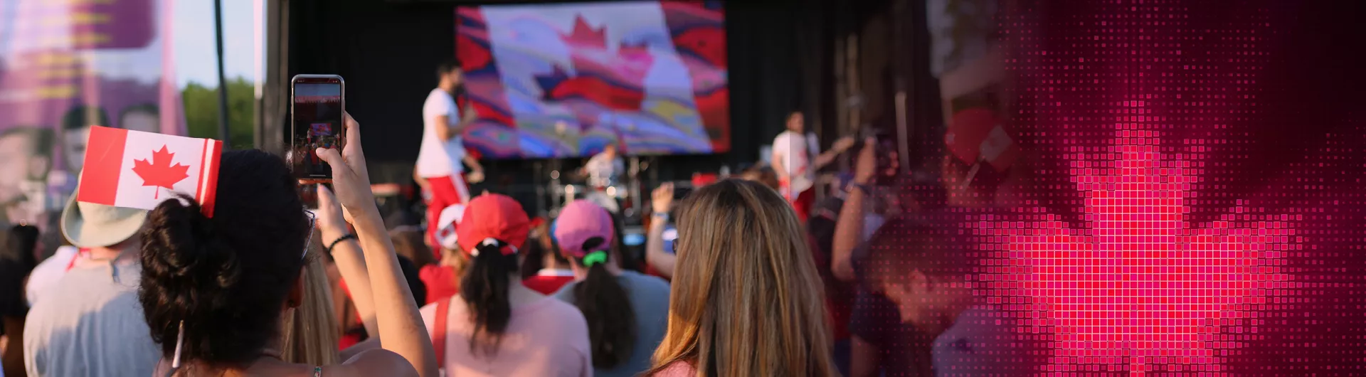 image with an audience watching a stage performance and Canadian flags