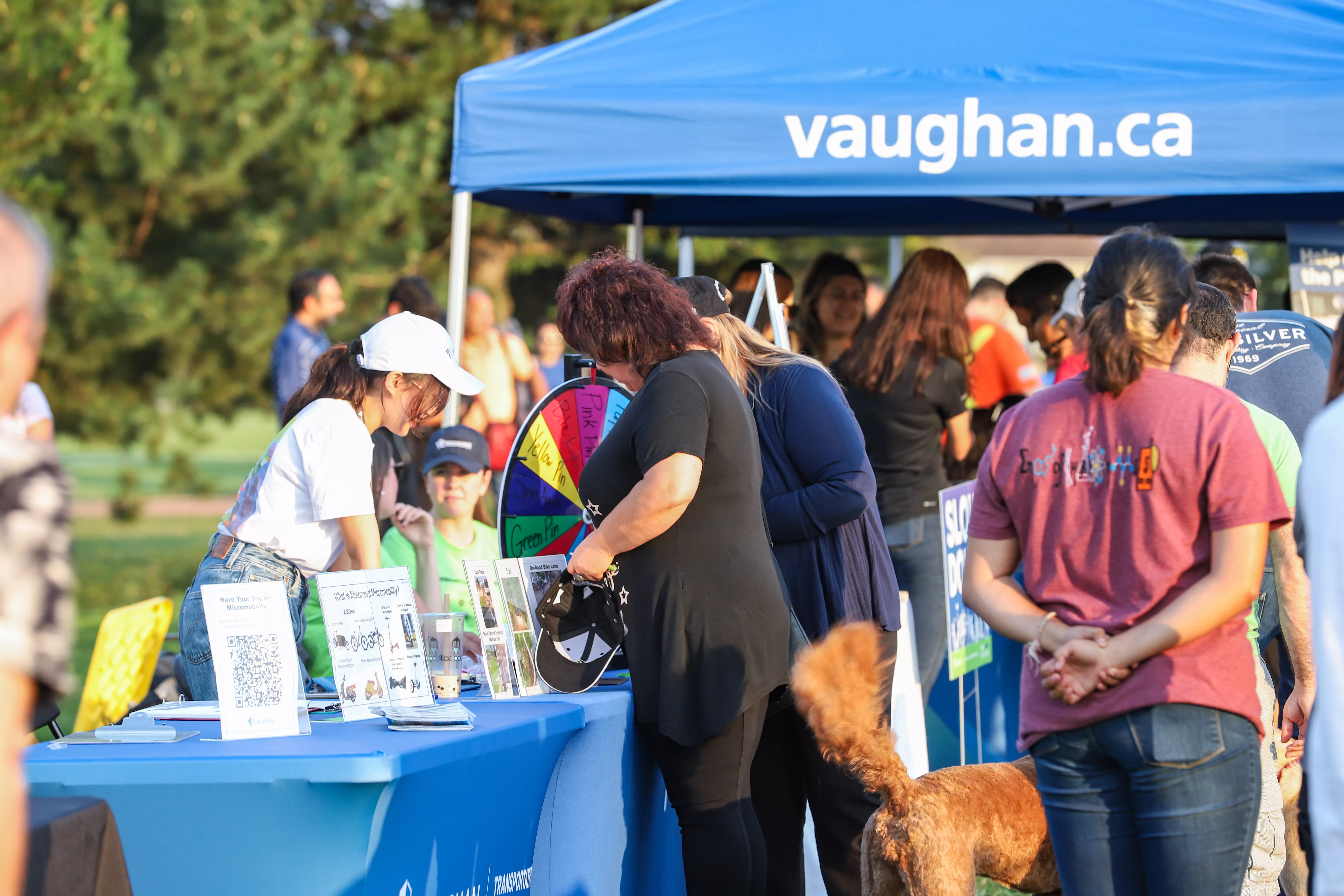 Youth ambassador speaking to a resident at an outdoor City of Vaughan event.