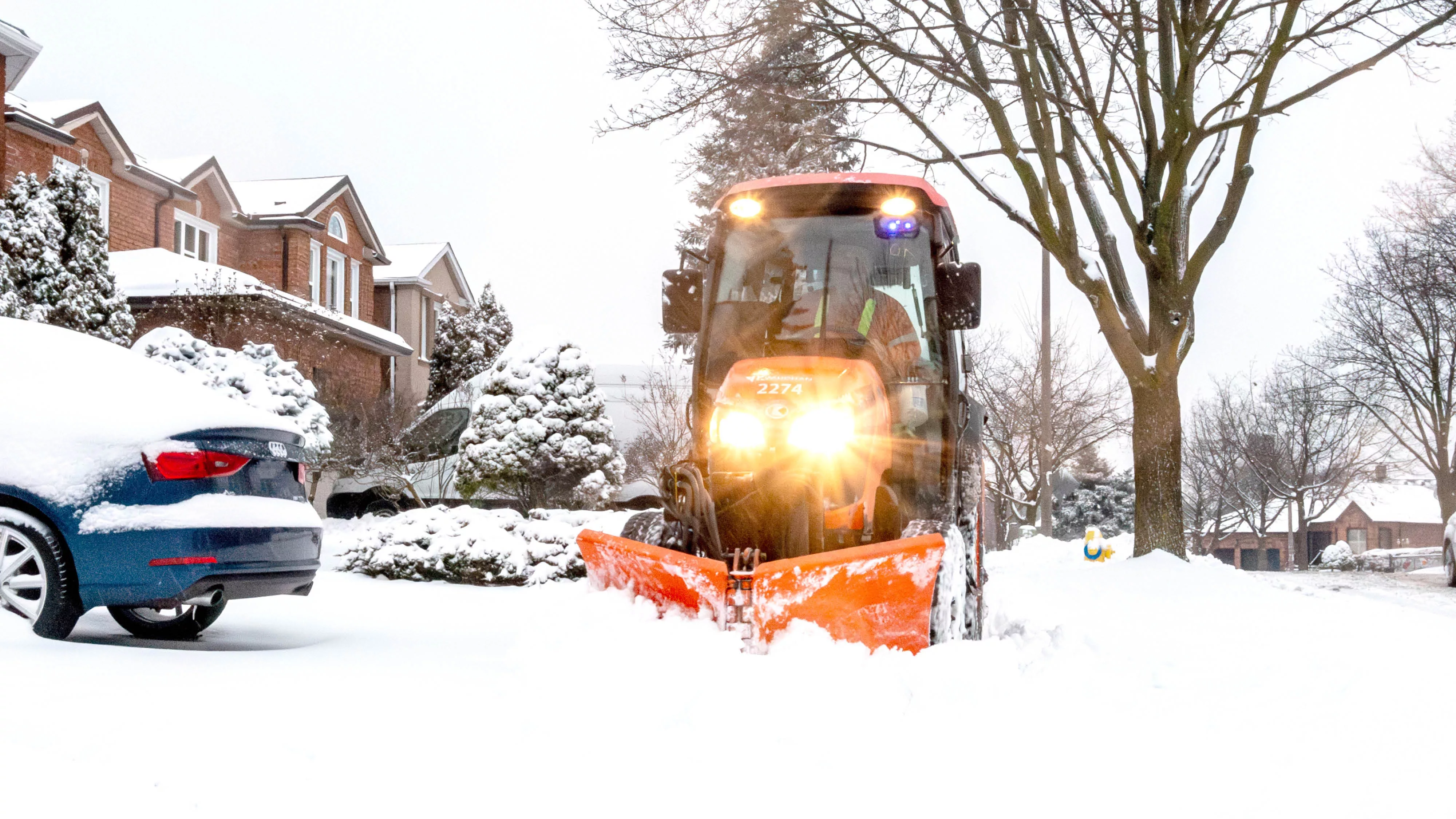 a sidewalk plow on a snowy day