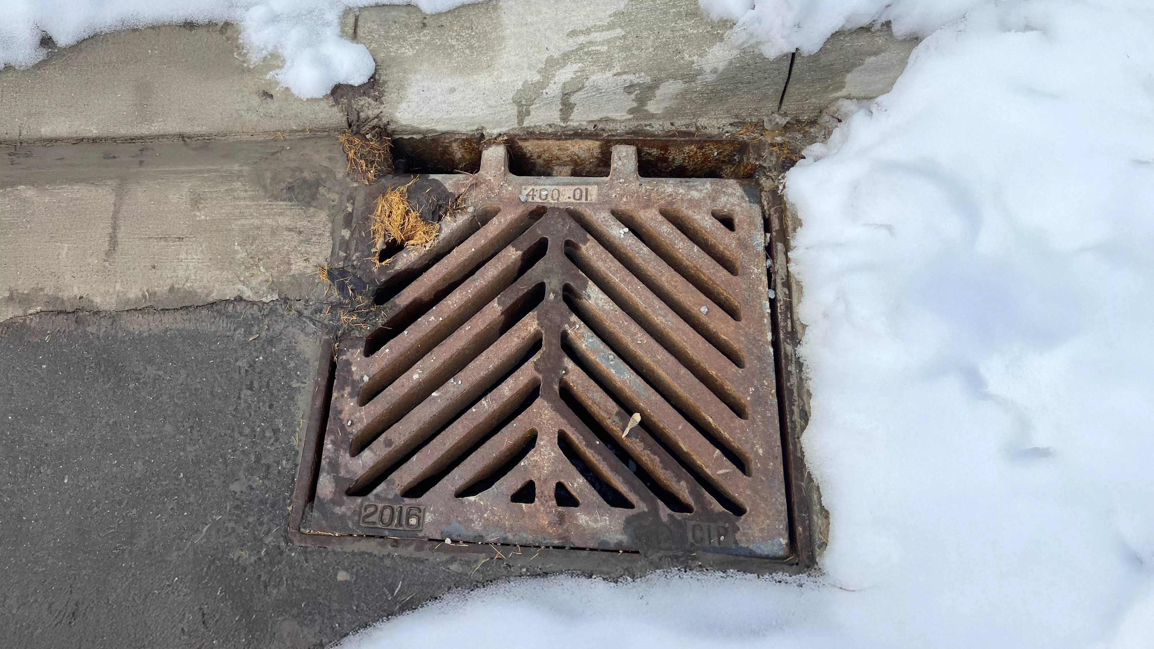 a catch basin with snow around it