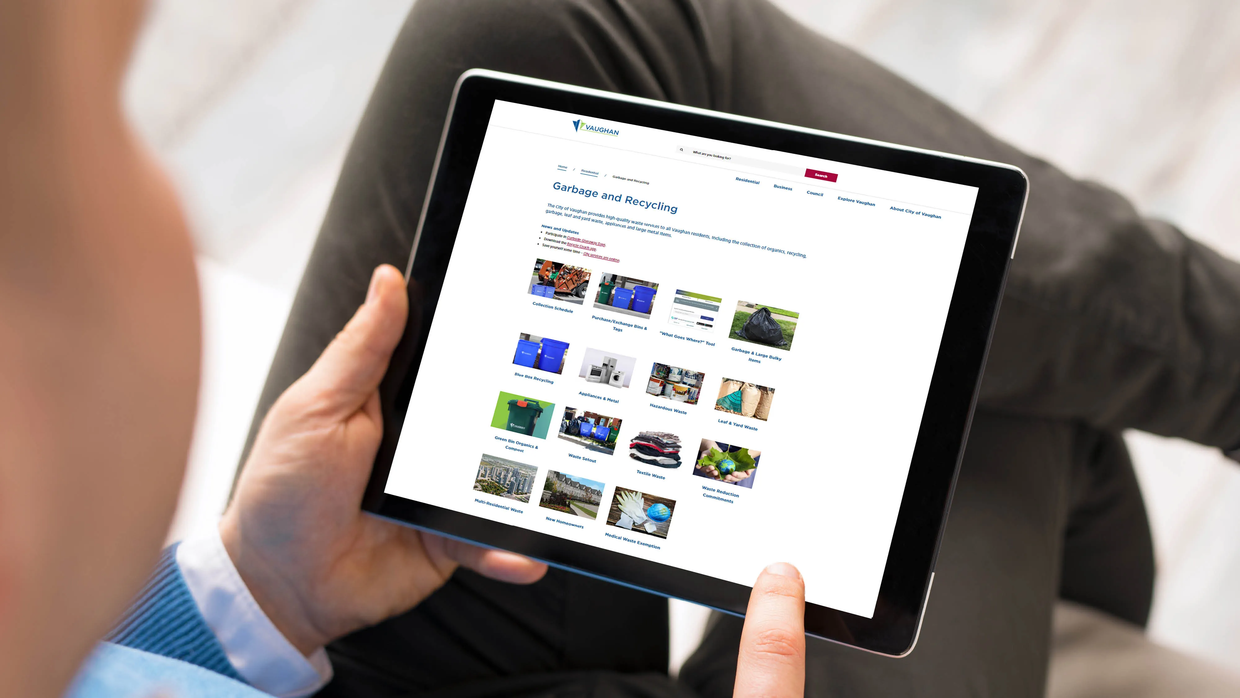 someone looking at vaughan.ca/waste on their tablet